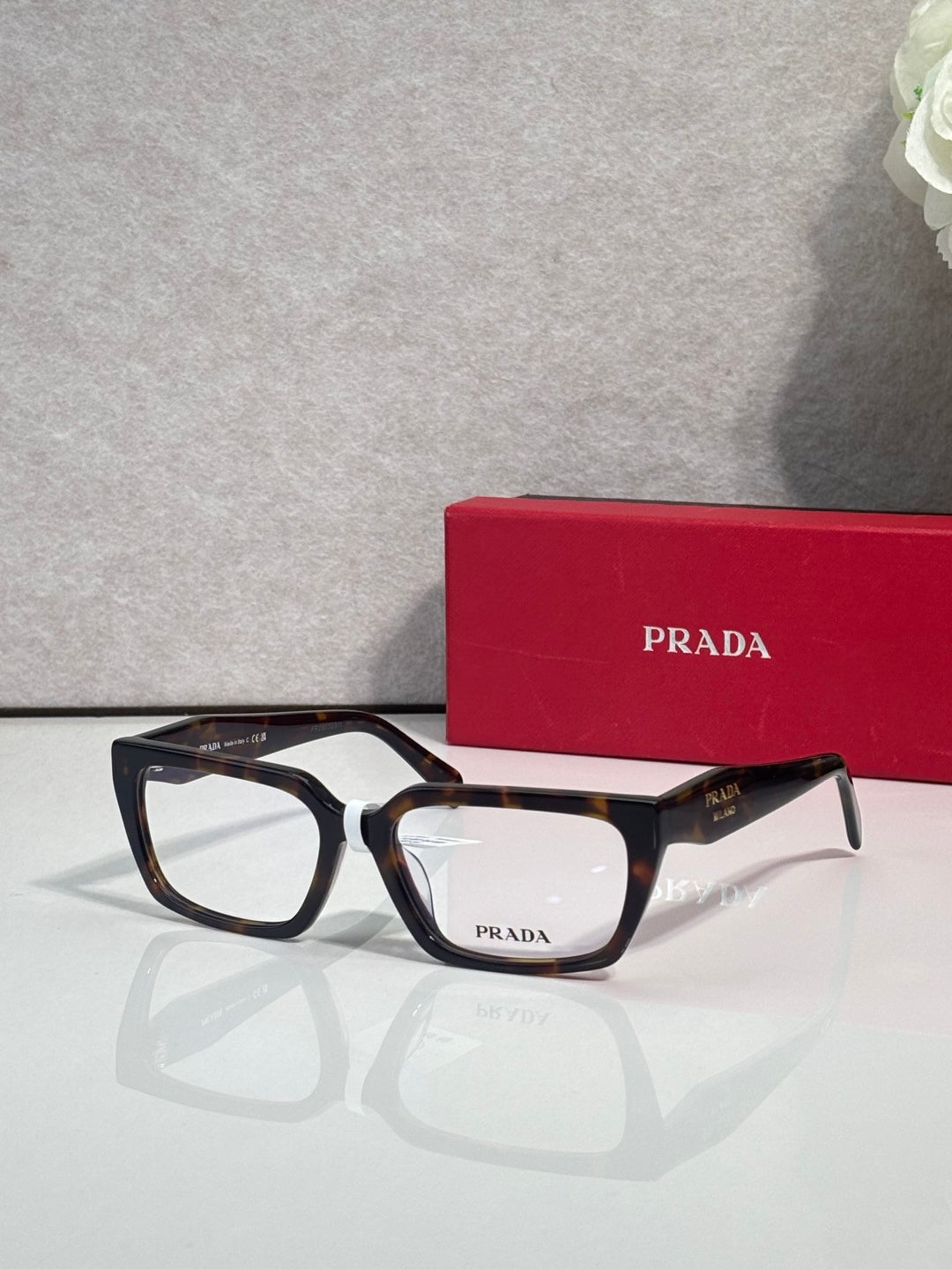 Prada eyeglasses with black and dark blue frame, rectangular clear lenses