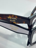Prada eyeglasses with tortoiseshell temple and gold Prada Milano lettering