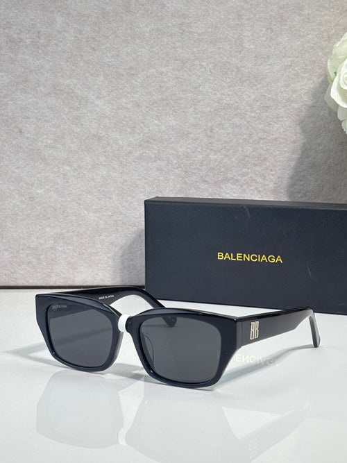 Balenciaga black sunglasses with angular frames and logo on temple