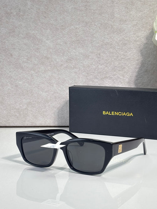 Balenciaga black sunglasses with dark lenses and chunky rectangular frames