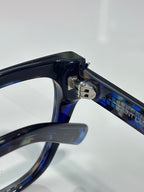 YSL blue-tinted eyeglasses arm and hinge close-up with logo on the bridge