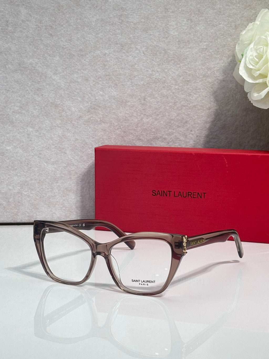 Tortoise-style eyeglasses with clear lenses and gold-tone bridge detail