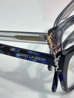 Blue patterned eyeglasses with SAINT LAURENT logo on temples and gold emblem