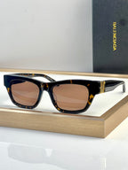 Tortoise acetate sunglasses with warm lenses and gold-tone bridge detail.