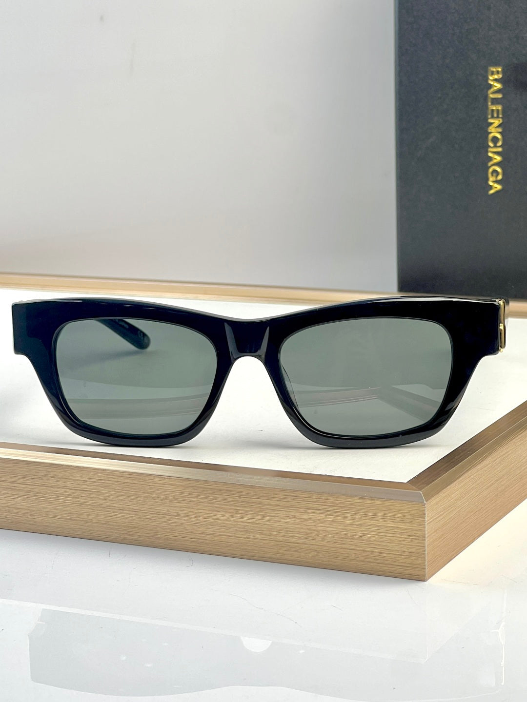 Navy acetate sunglasses with square lenses and gold-tone temple detail.