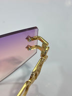 Louis Vuitton sunglasses close-up of gold-tone frame hinge and earhook with lens edge