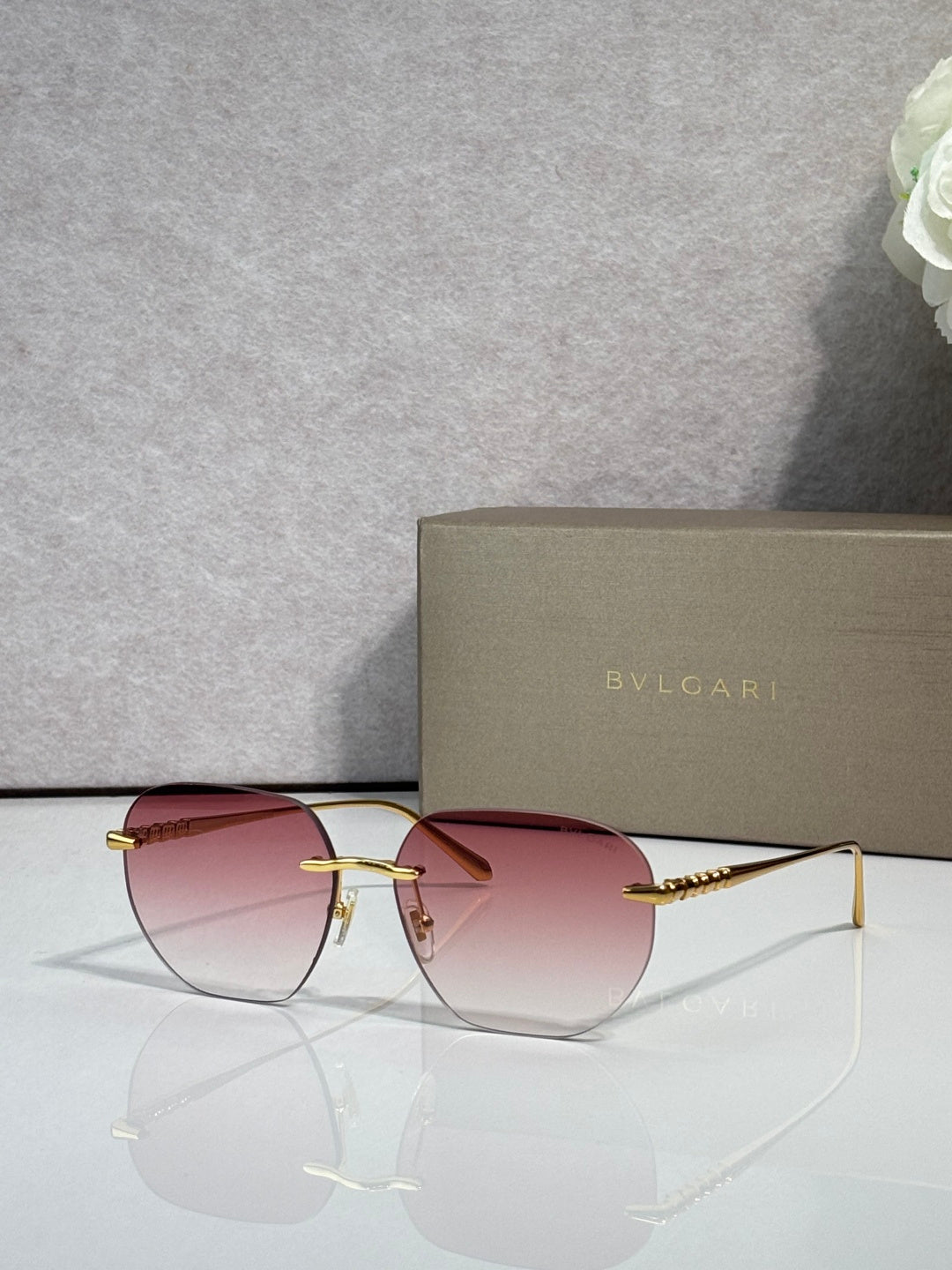 Gold metal round sunglasses with tinted rose lenses and burgundy accents.