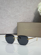 Gold metal round sunglasses with dark lenses and black temples, thin frame.