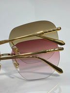 Gold metal round sunglasses with rose-tinted lenses and slim articulated temples.
