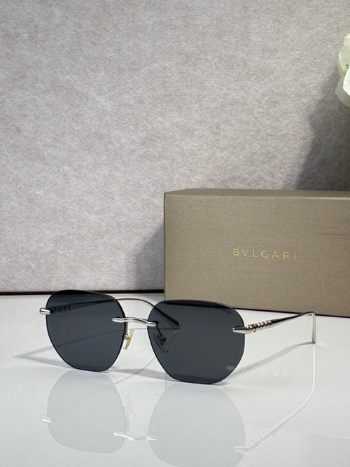 Gold metal round sunglasses with dark lenses and black arms, with nose bridge.