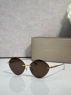 Round brown sunglasses with gold-tone metal frame and dark tinted lenses