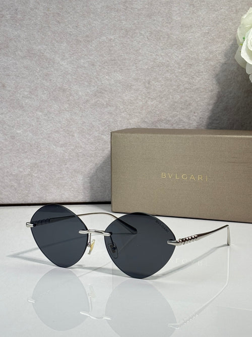 Round dark sunglasses with thin metal frame and gold-tone hinges