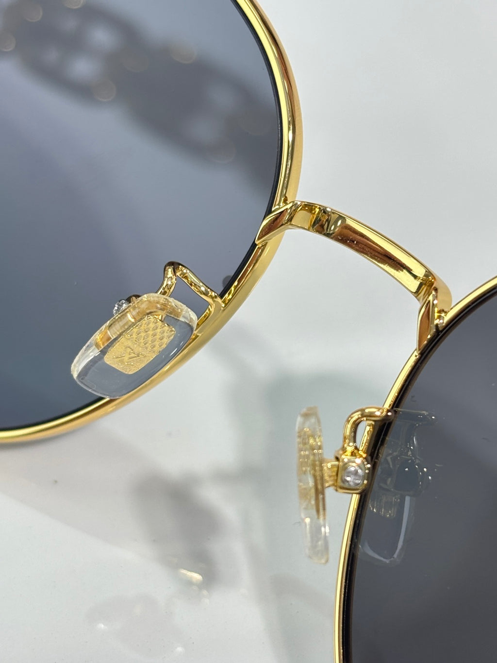 Louis Vuitton gold-tone sunglasses close-up of lens and bridge