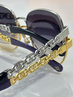Louis Vuitton sunglasses with gold and silver chain detail on dark lenses