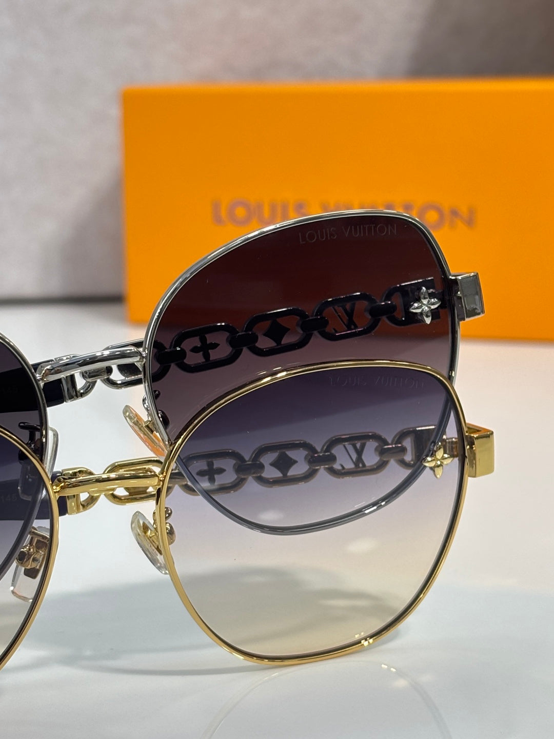 Louis Vuitton round sunglasses with printed logo lenses and gold frame