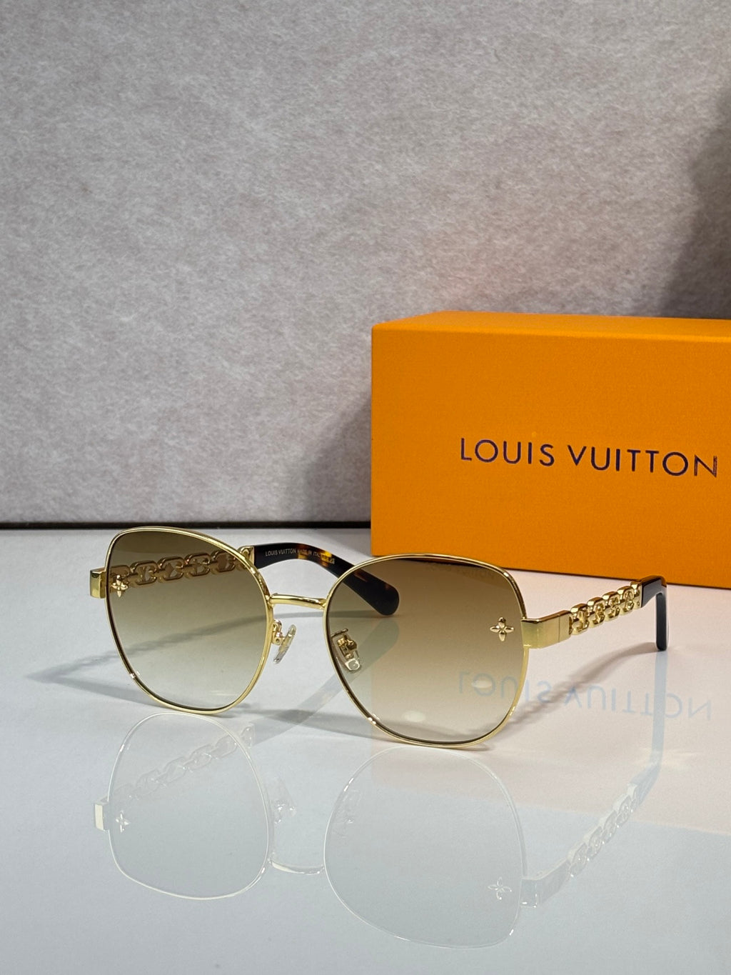 Louis Vuitton gold-tone sunglasses with gradient lenses and logo temple detail