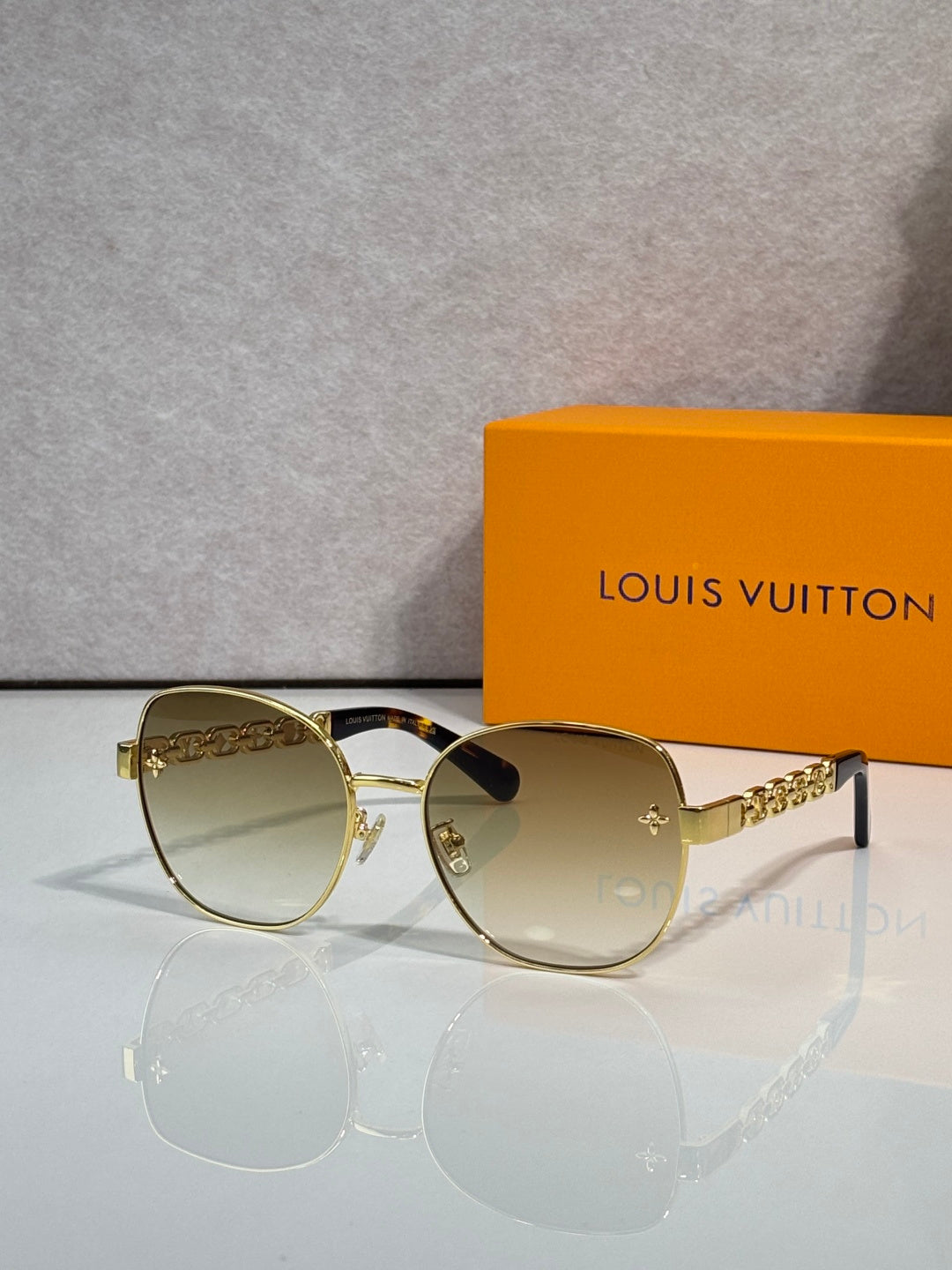 Louis Vuitton gold-tone sunglasses with gradient lenses and logo temple detail
