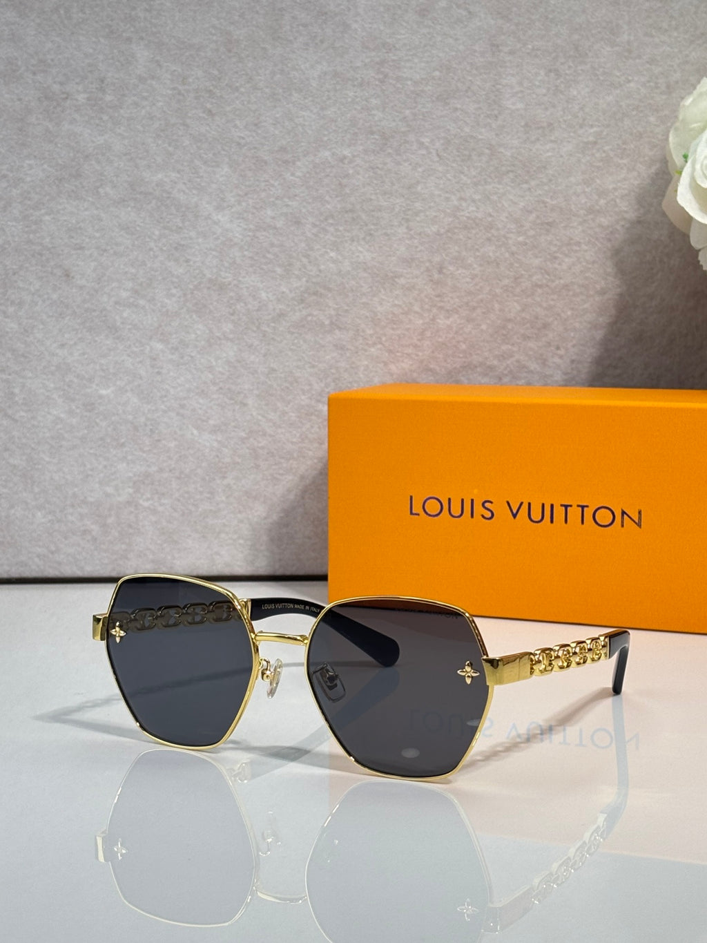 Louis Vuitton sunglasses with gold-tone frame and dark tinted lenses