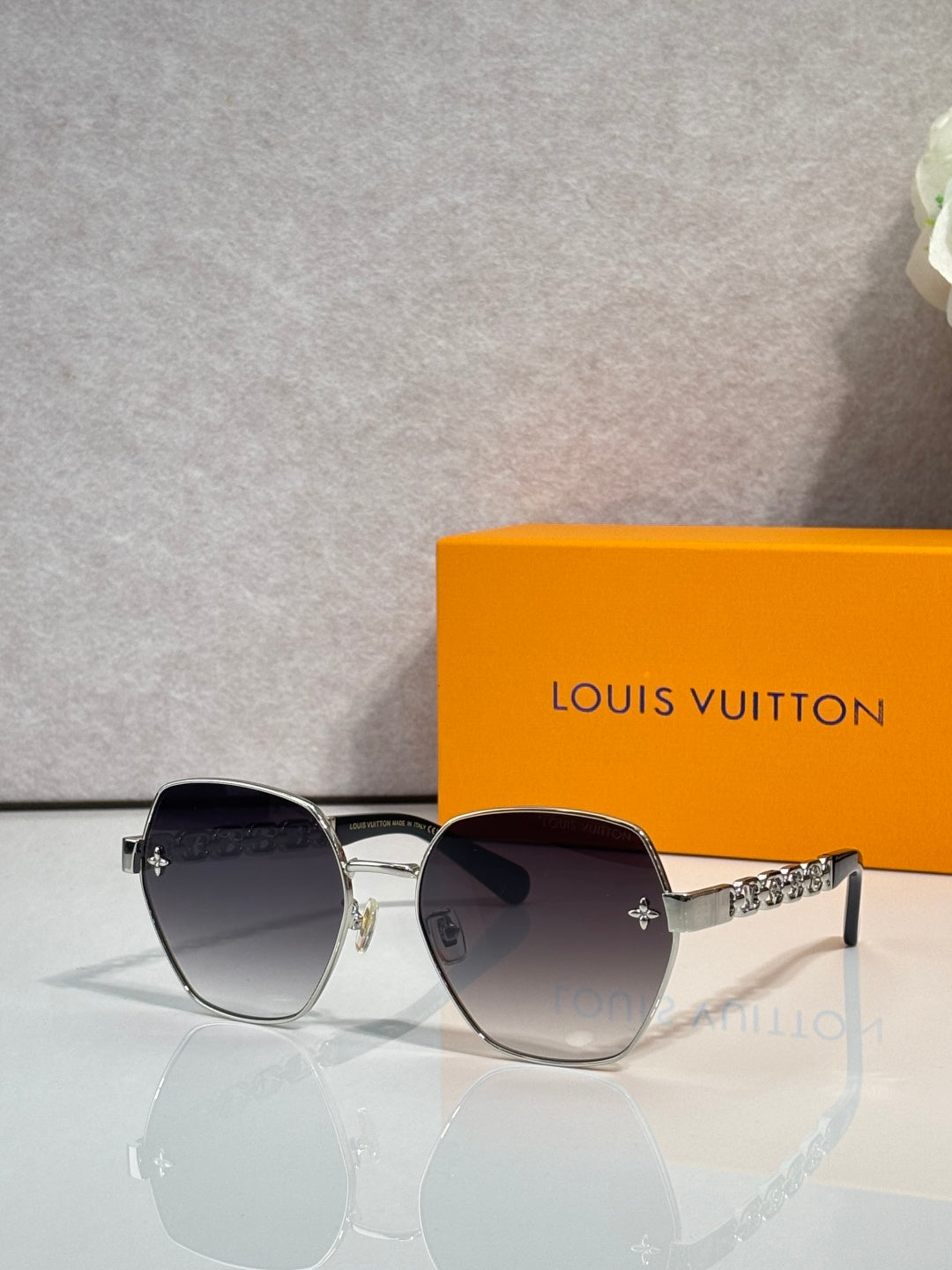 Louis Vuitton sunglasses with silver-tone frame, dark tinted lenses, logo on temple