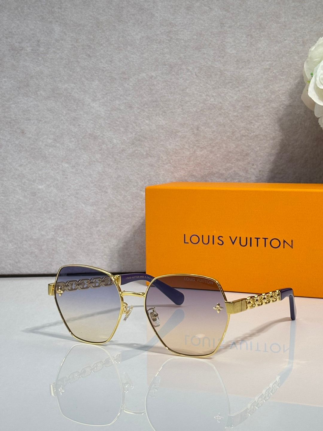 Louis Vuitton sunglasses with gold-tone frame and dark tinted lenses