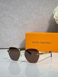 Louis Vuitton sunglasses with gold-tone frame, dark tinted lenses, logo temple details