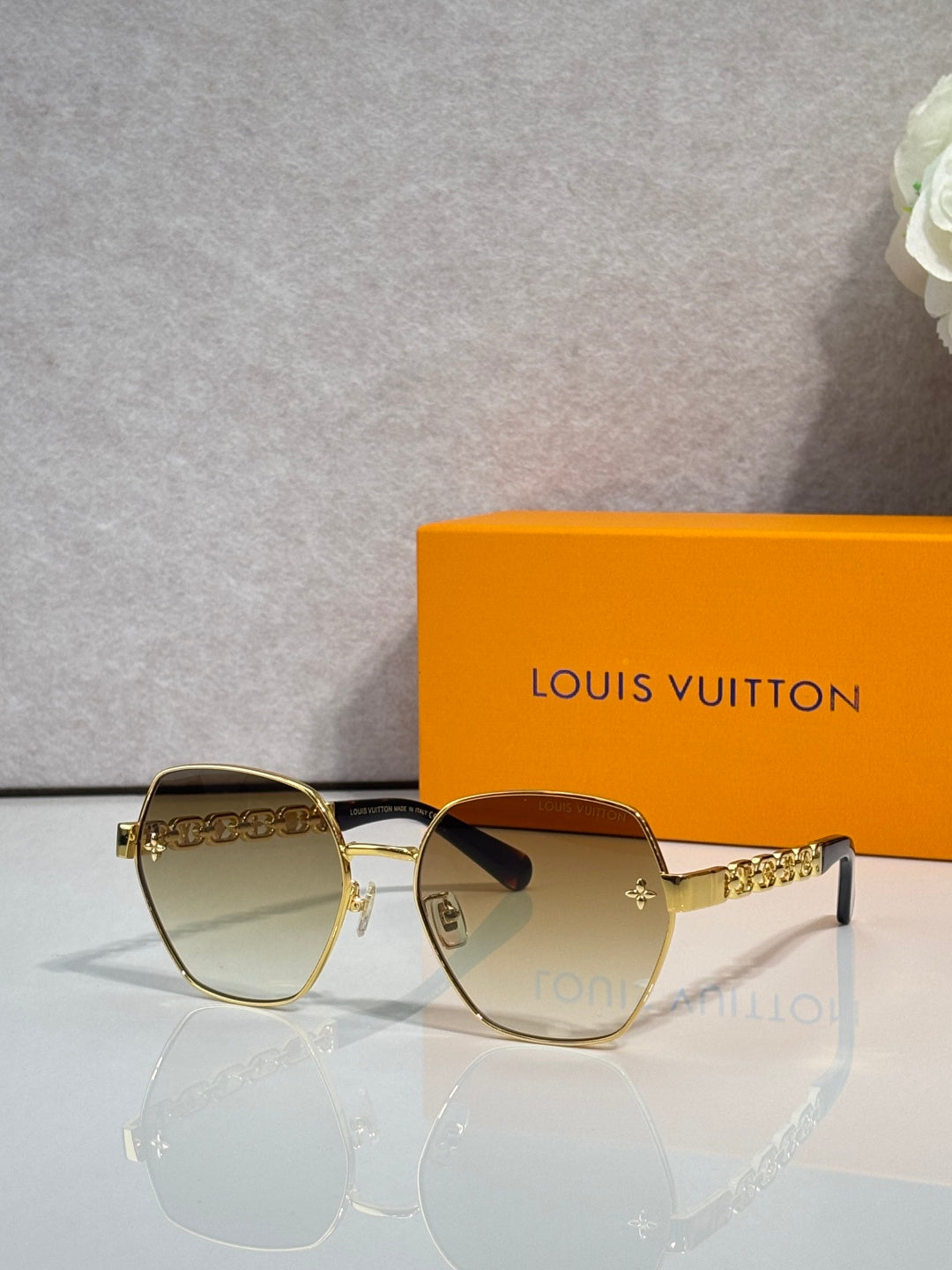 Louis Vuitton sunglasses with gold-tone frame and light-tinted lenses