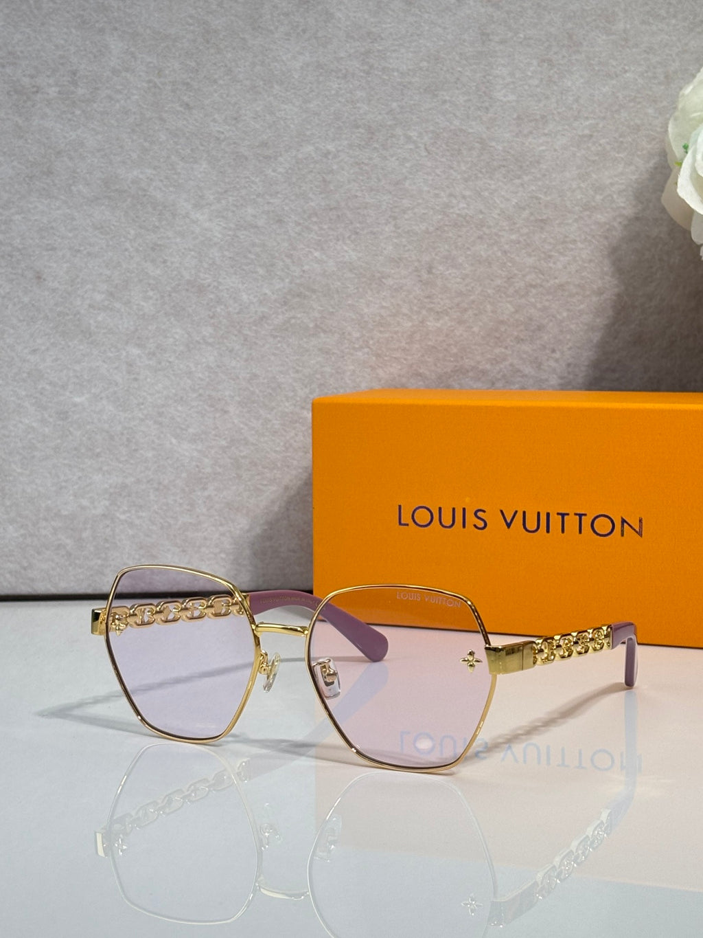 Louis Vuitton sunglasses with gold-tone frame and pink-tinted lenses