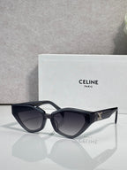 Celine cat-eye sunglasses with glossy black frames and gold logo detail