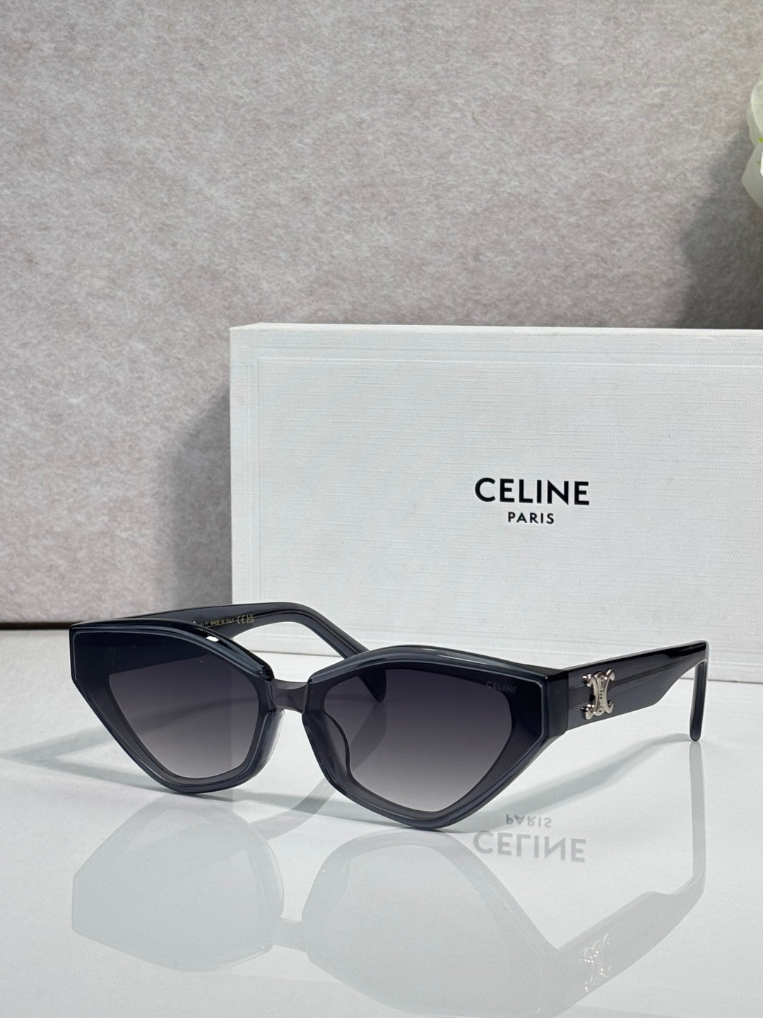 Celine cat-eye sunglasses with glossy black frames and gold logo detail