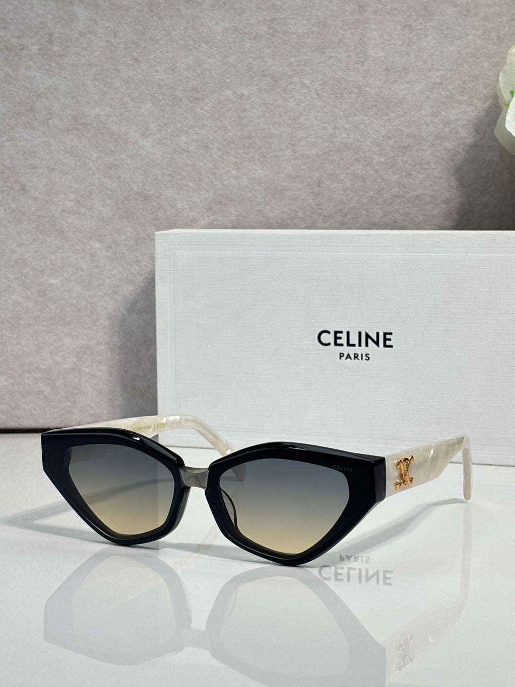 Celine cat-eye sunglasses with black frames and gold logo at the temple