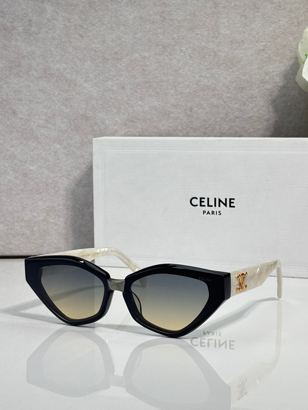 Celine cat-eye sunglasses with black frames and gold logo at the temple