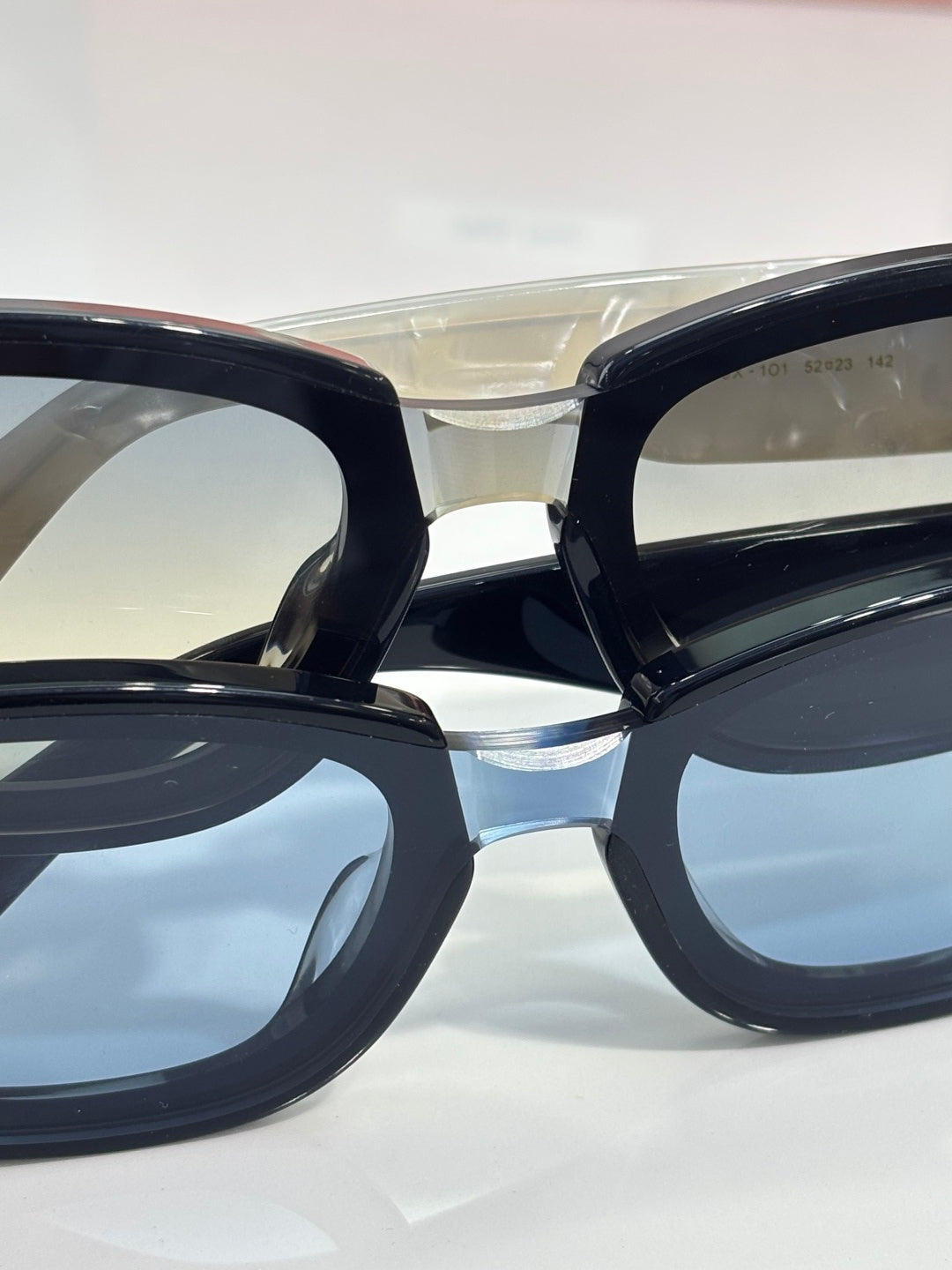 MiuMiu sunglasses close-up with dark frames and reflective lenses