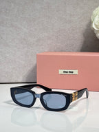 MiuMiu sunglasses with blue-tinted lenses and dark frames