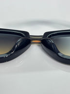 Prada glasses with glossy black frames, front bridge close-up
