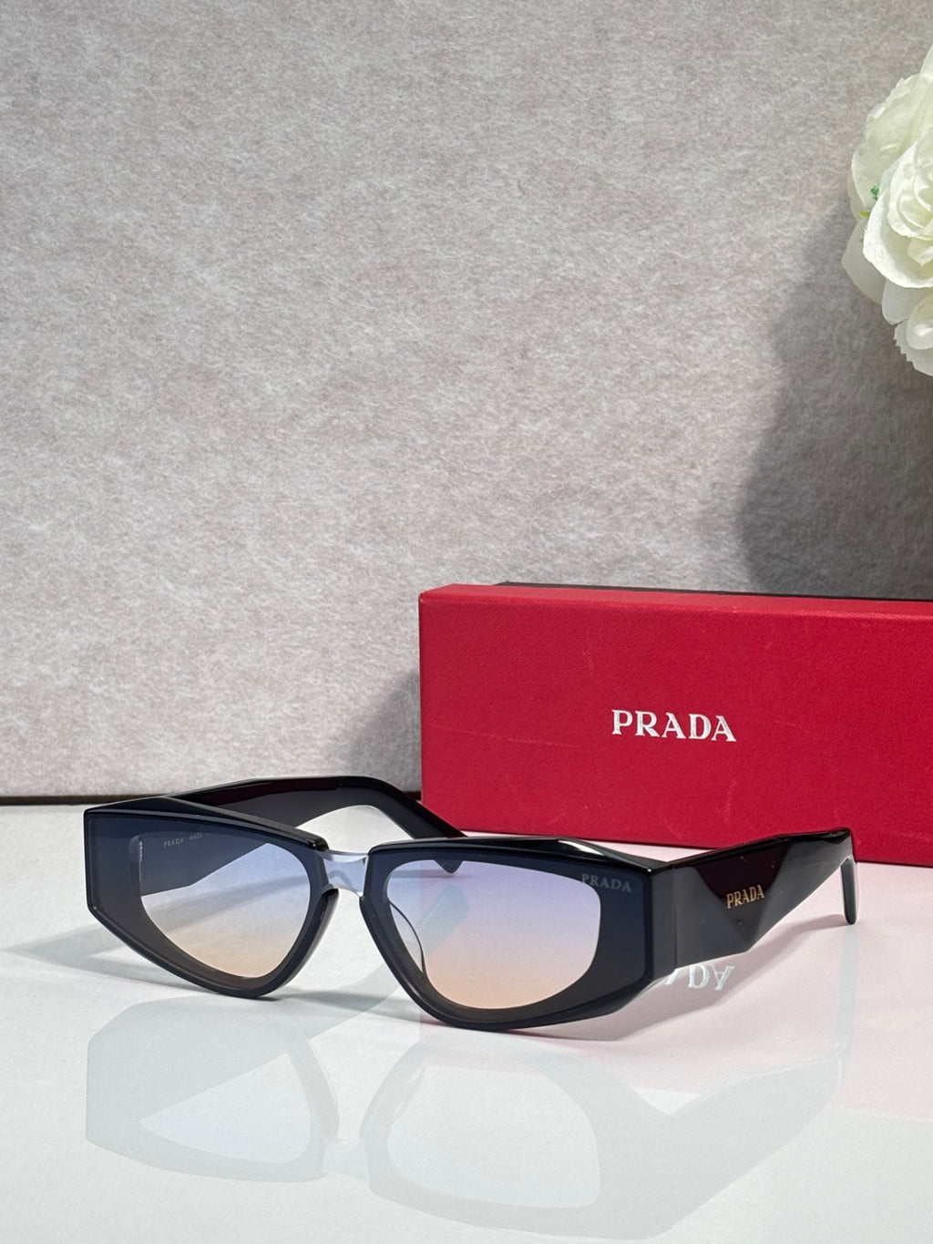 Prada glasses with black frames and tinted lenses, front view