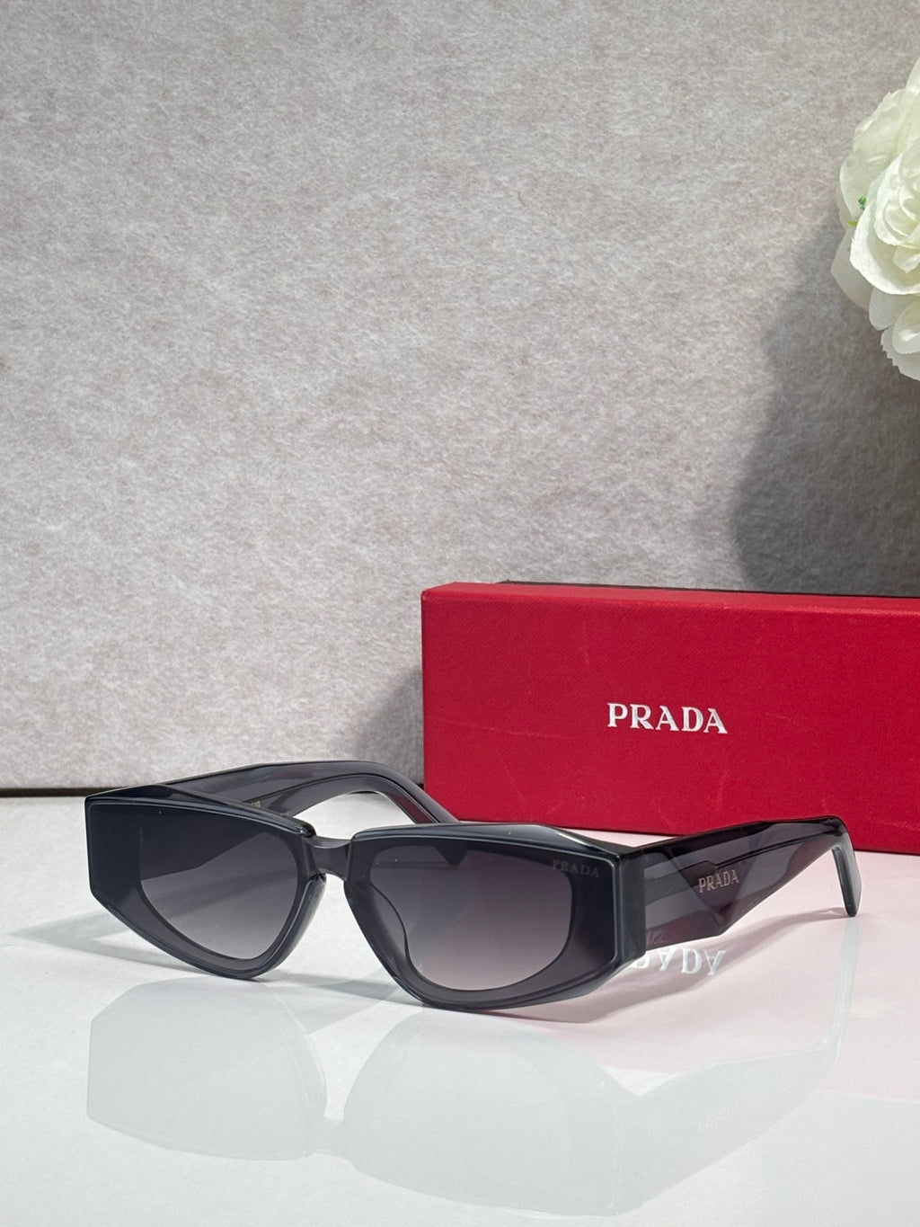 Prada glasses with dark frames and tinted lenses, angled side view