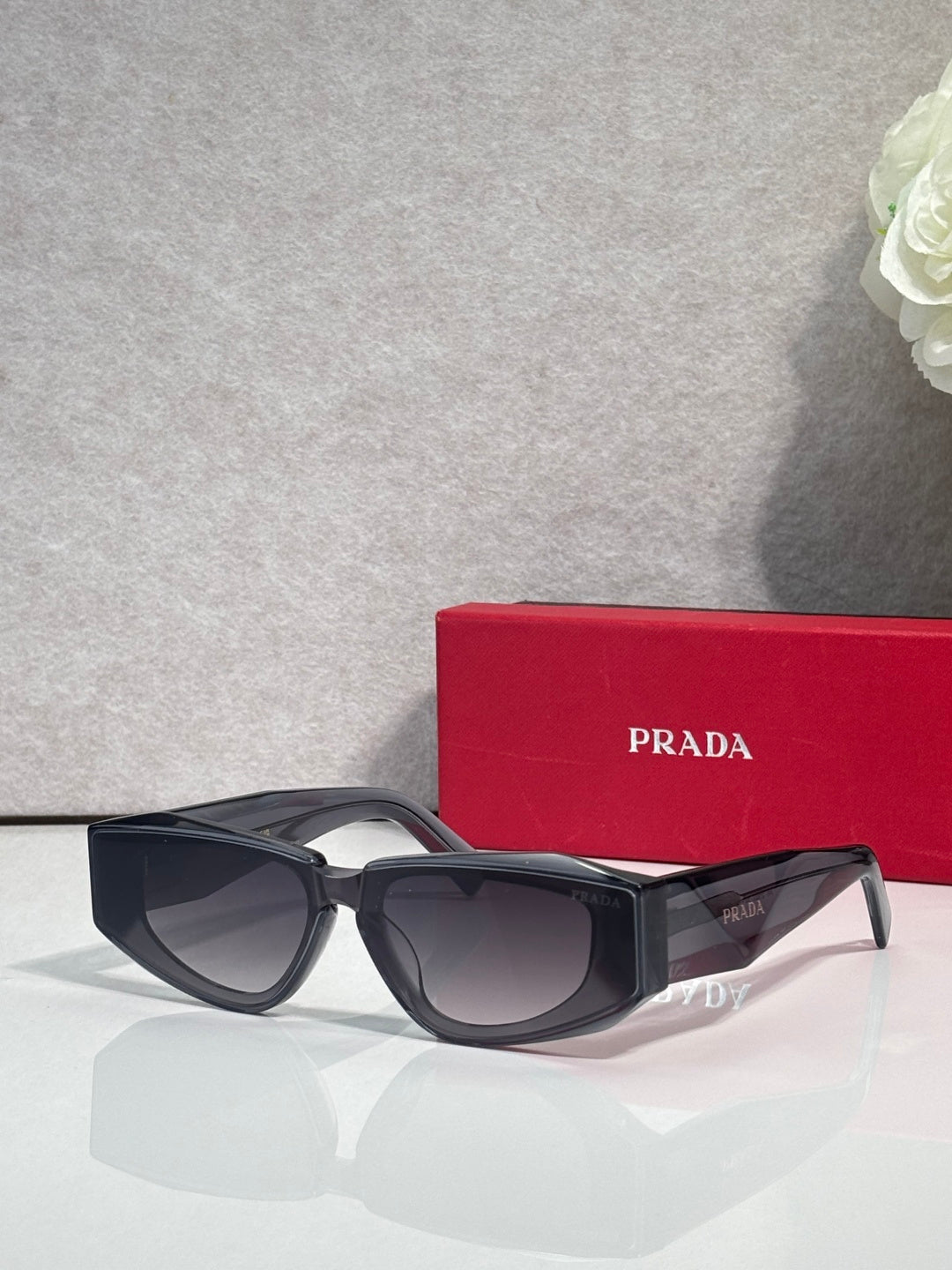 Prada glasses with dark frames and tinted lenses, angled side view