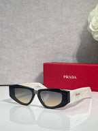 Prada glasses with black frames and tinted lenses, angled front view