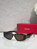 Prada glasses with dark tortoiseshell frames and tinted lenses, side profile