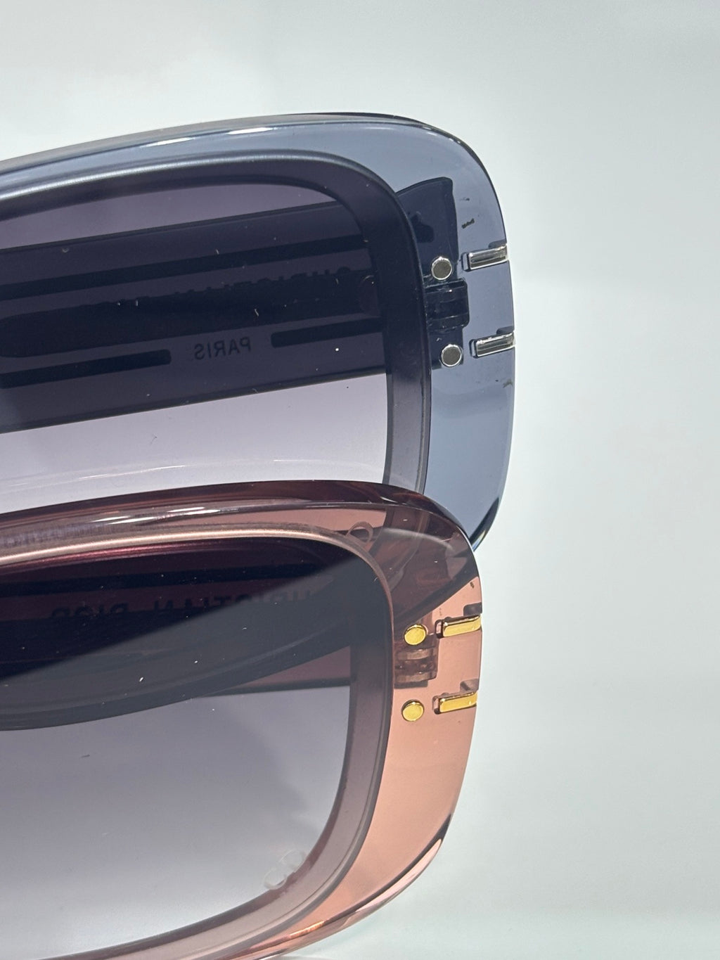 Dior sunglasses close-up showing stacked lenses and mixed frame tones
