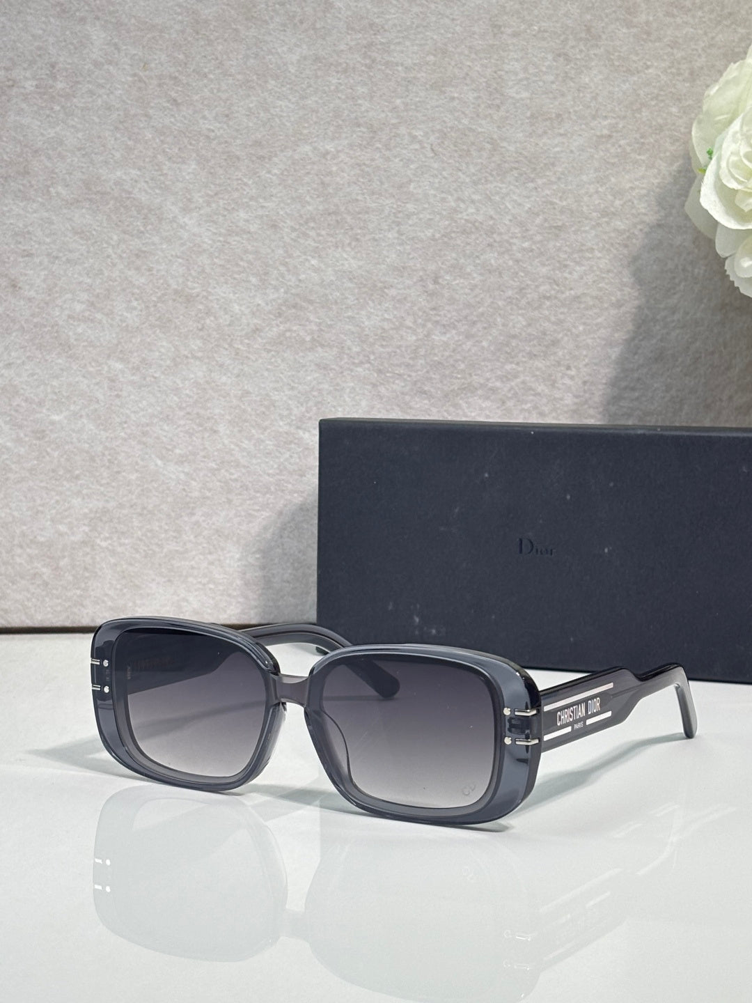 Dior sunglasses with dark blue square frames and dark tinted lenses