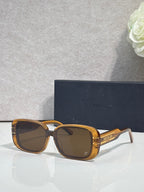 Dior sunglasses with amber square frames and dark tinted lenses