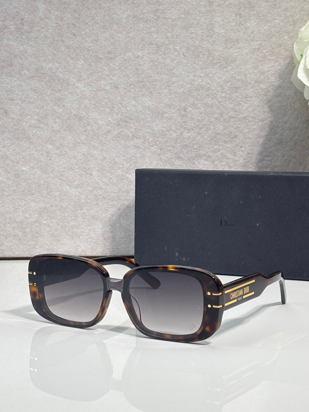 Dior sunglasses with tortoiseshell square frames and dark tinted lenses