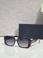Dior sunglasses with tortoiseshell square frames and dark tinted lenses