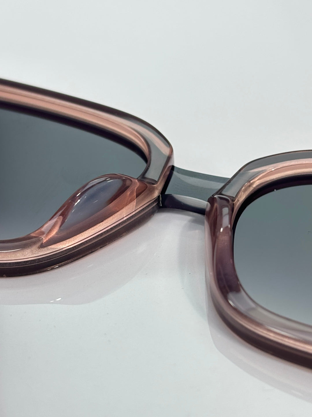 Dior sunglasses close-up of rose-hued frames and dark lenses