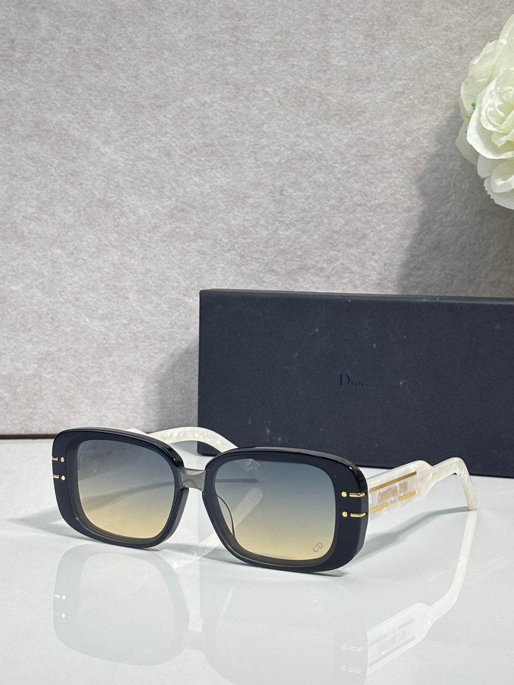 Dior sunglasses with dark square frames and pale gradient lenses