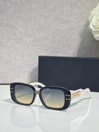 Dior sunglasses with dark square frames and pale gradient lenses