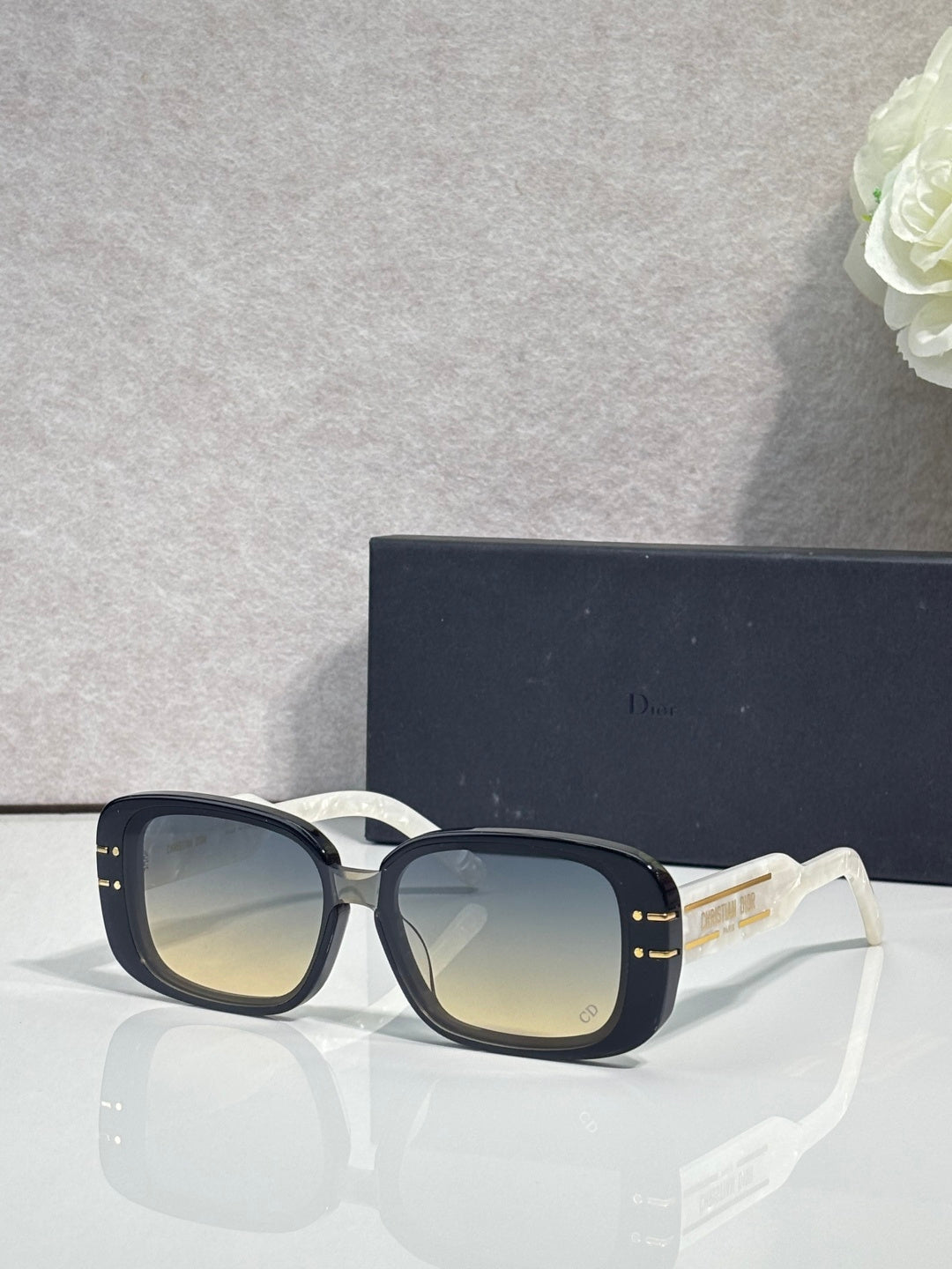 Dior sunglasses with dark square frames and pale gradient lenses