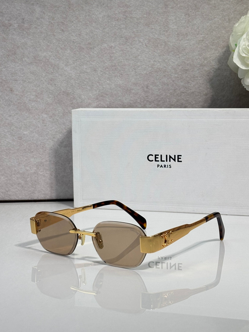 Celine sunglasses with tortoiseshell frames and dark lenses, gold-tone hinge details