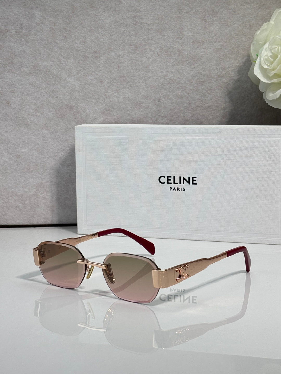 Celine sunglasses with brown frames, gradient lenses, and dark red temples with gold logo